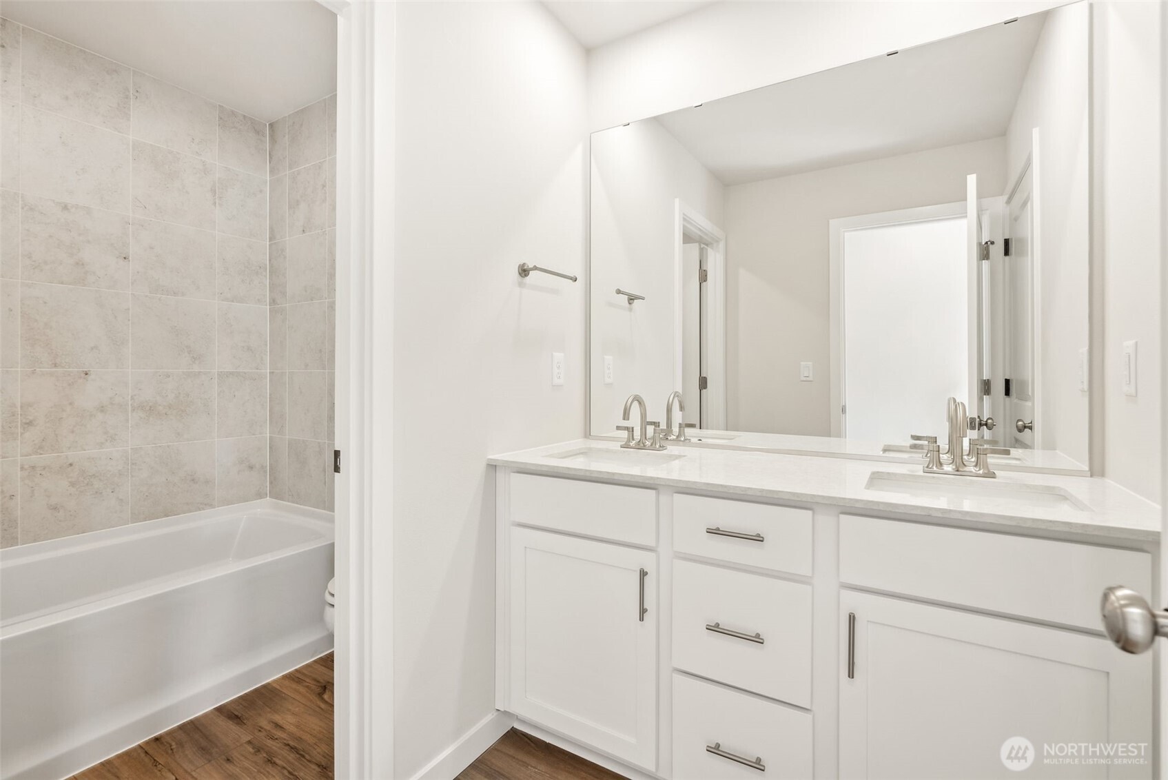 2064 Northeast Norseman Way Poulsbo, WA 98370 - Photo 25 of 28 a bathroom with a double vanity sink a mirror and a bathtub