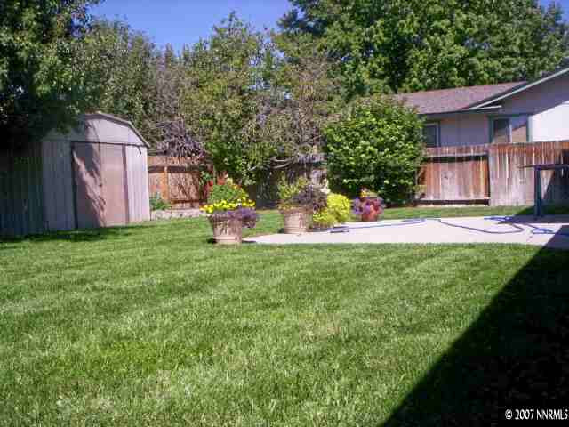 4315 Valdez Way Reno, NV 89502 - Photo 8 of 9 a backyard of a house with table and chairs plants and large tree