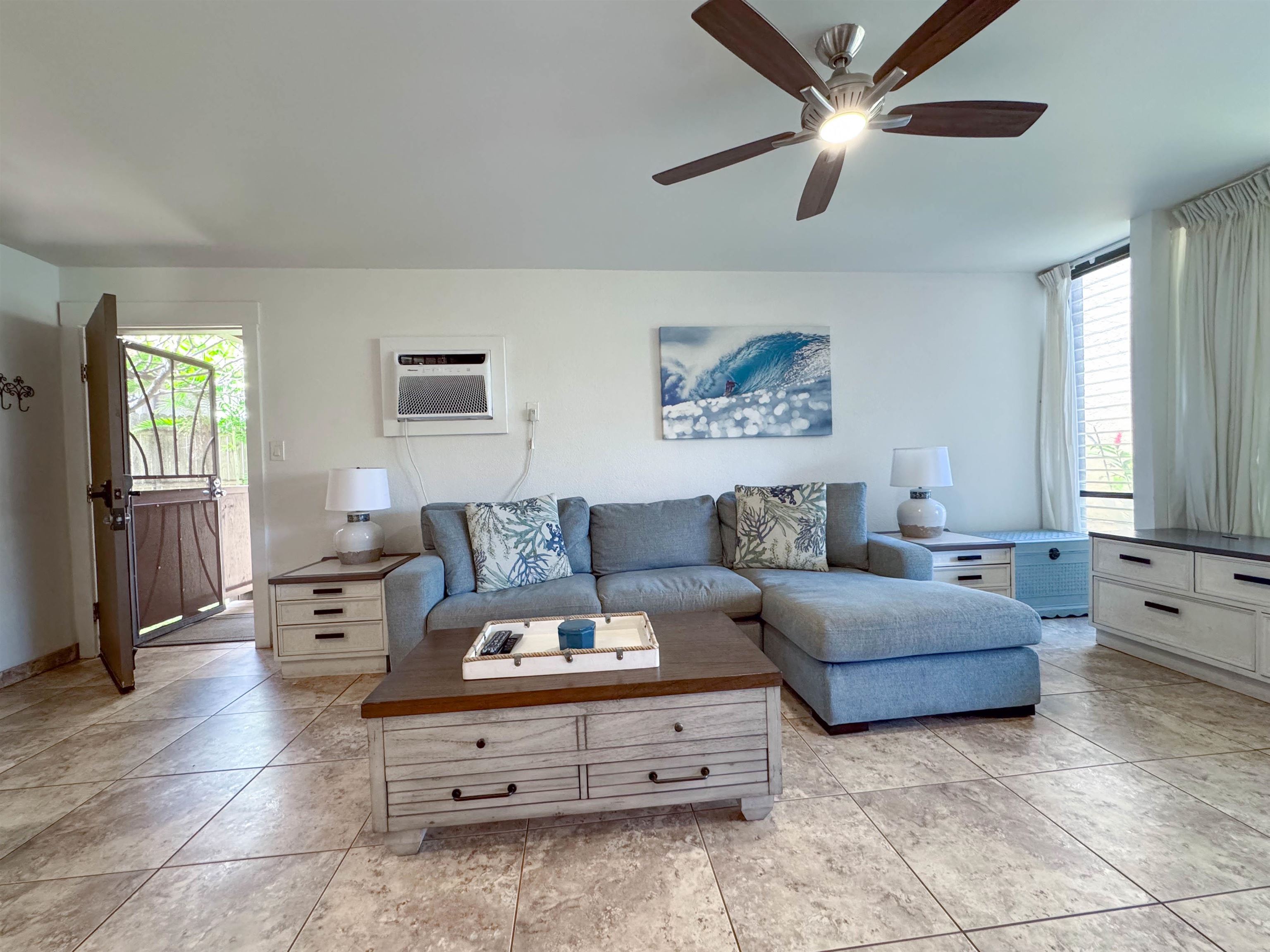 483 South Kihei Road, Unit 115 Kihei, HI 96753 - Photo 12 of 36 a living room with furniture and a large window