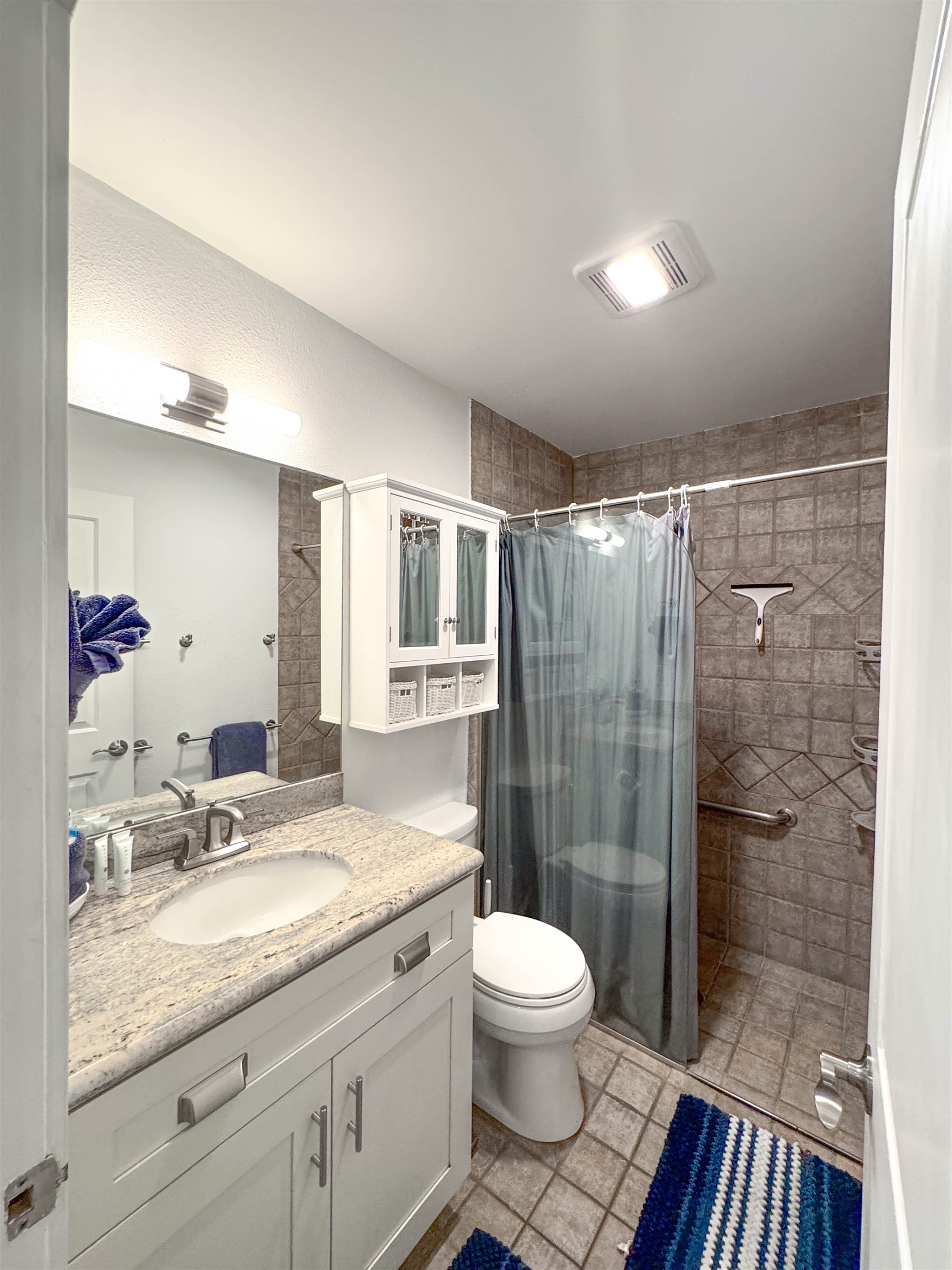 483 South Kihei Road, Unit 115 Kihei, HI 96753 - Photo 16 of 36 a bathroom with a granite countertop sink toilet and shower