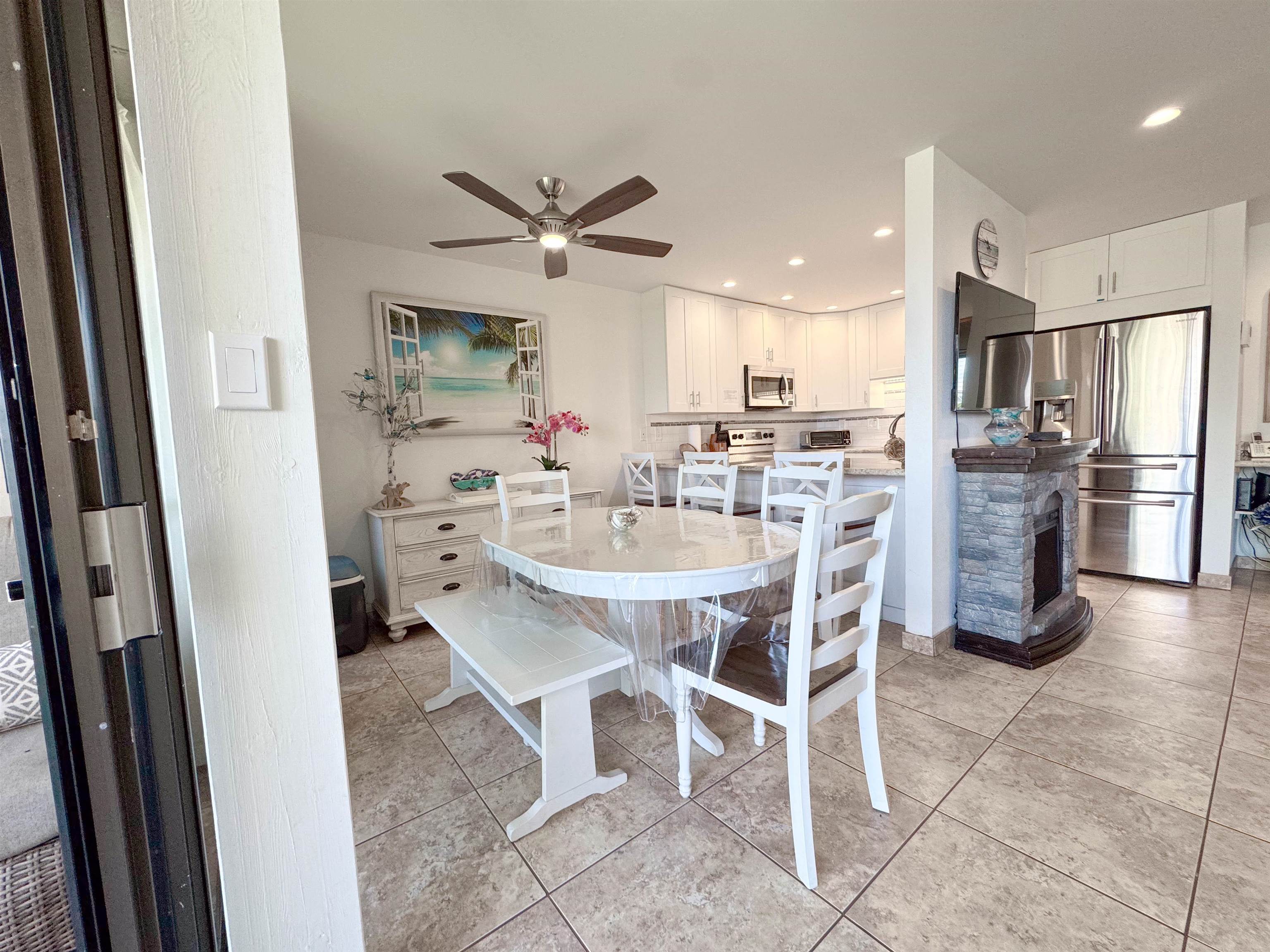 483 South Kihei Road, Unit 115 Kihei, HI 96753 - Photo 2 of 36 a dining room with stainless steel appliances a dining table and chairs