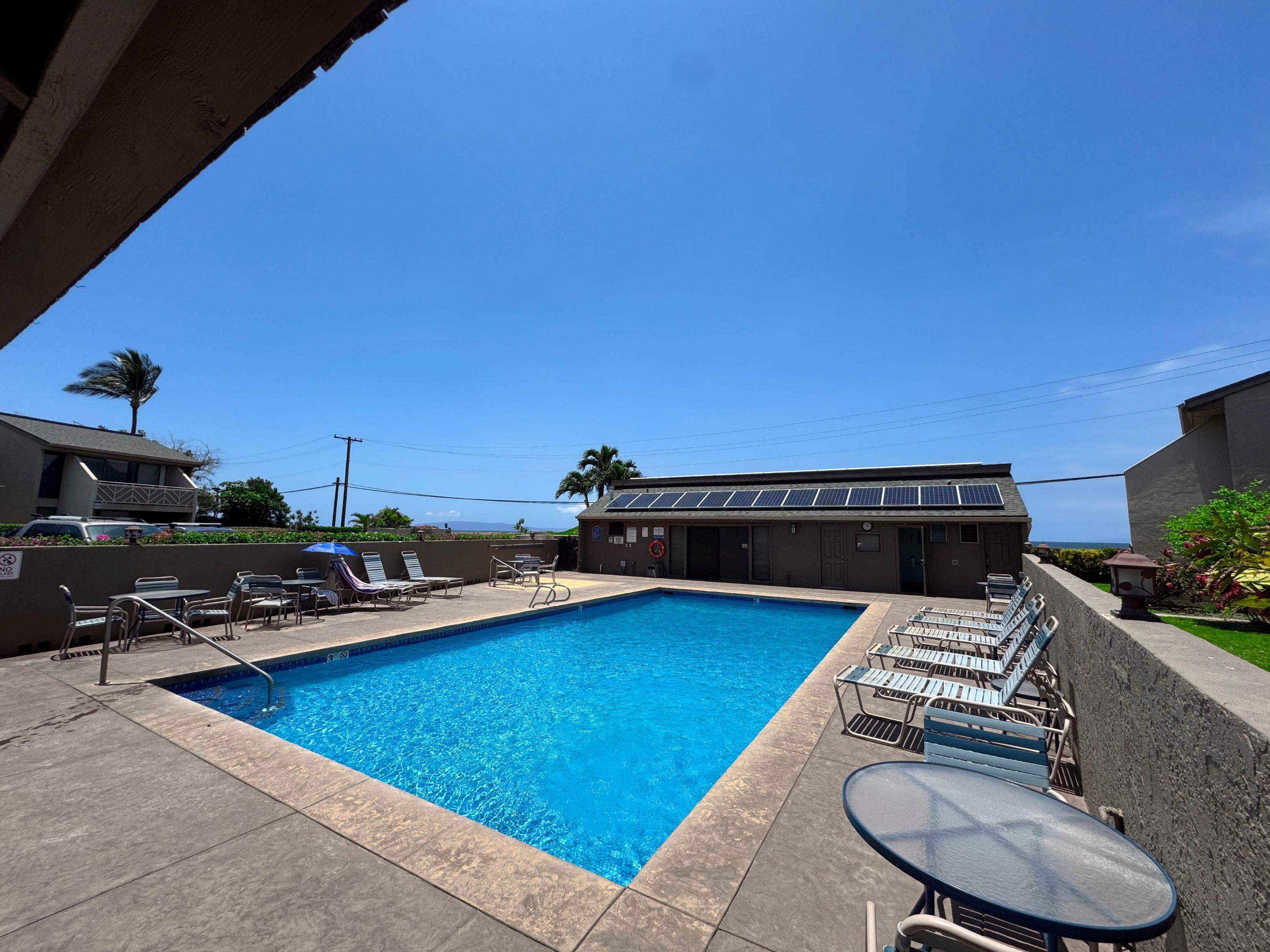 483 South Kihei Road, Unit 115 Kihei, HI 96753 - Photo 24 of 36 a roof deck with table and chairs a barbeque