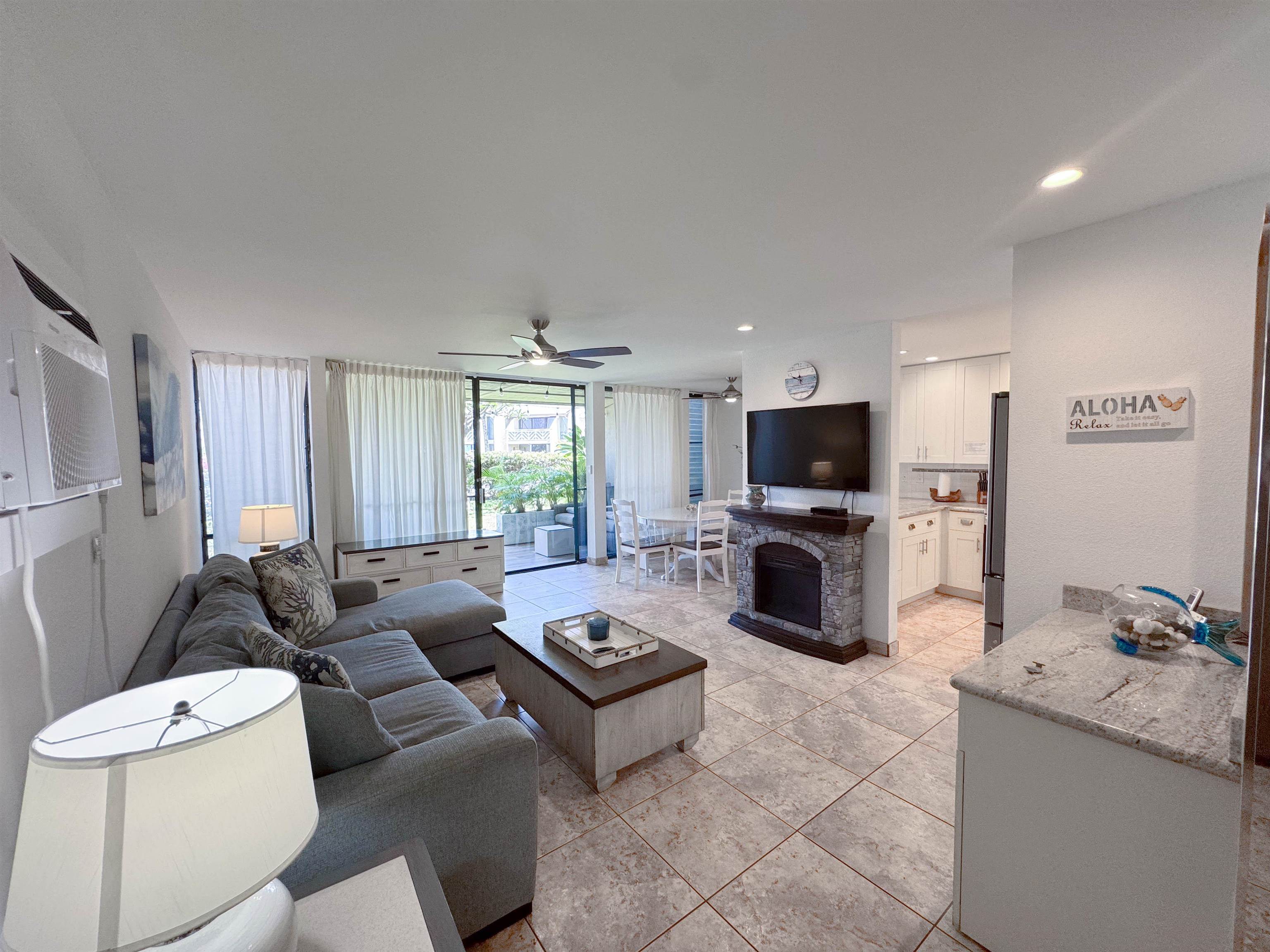 483 South Kihei Road, Unit 115 Kihei, HI 96753 - Photo 4 of 36 a living room with furniture and a flat screen tv