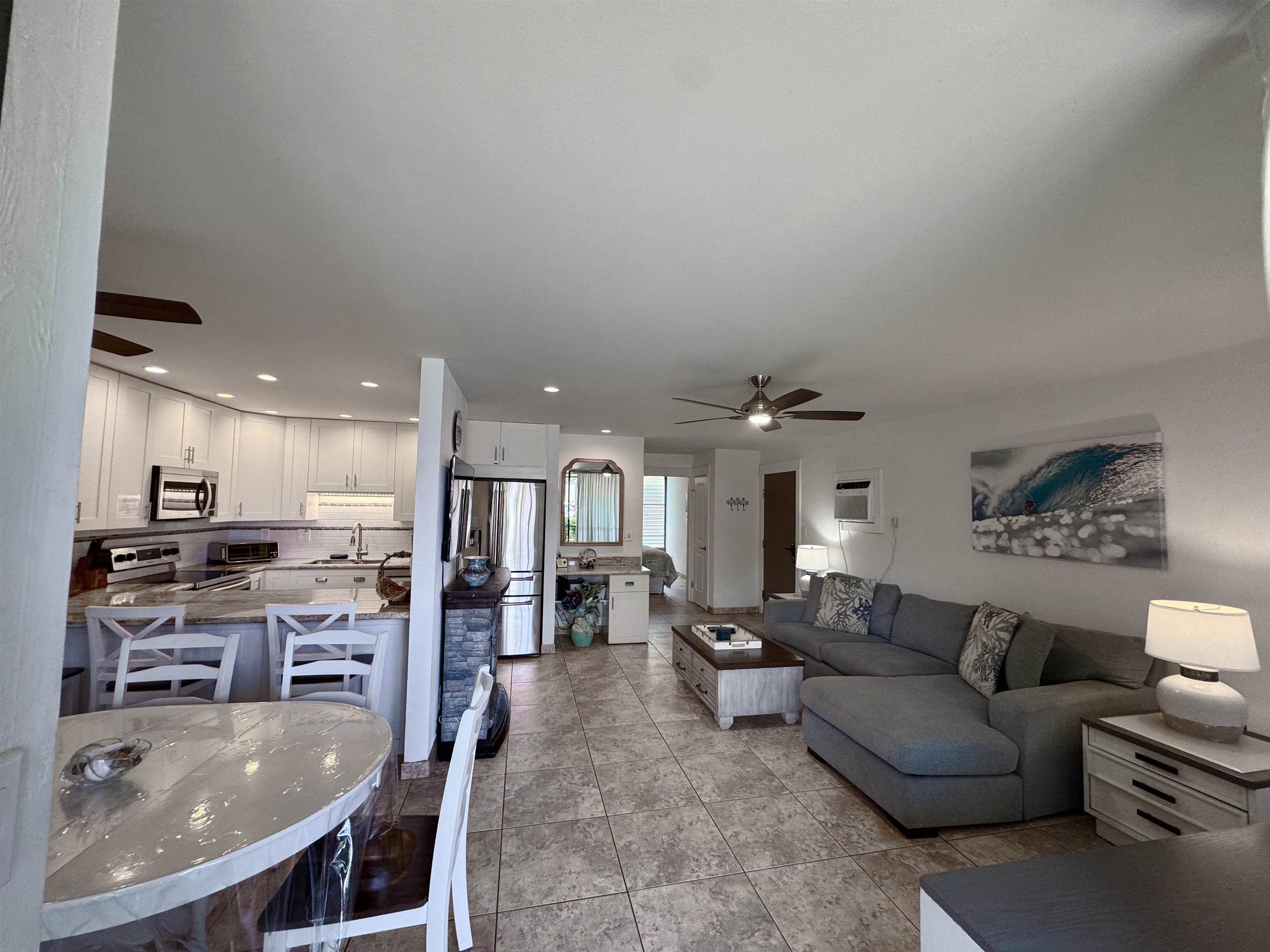 483 South Kihei Road, Unit 115 Kihei, HI 96753 - Photo 9 of 36 a living room with stainless steel appliances furniture a kitchen view and a kitchen view