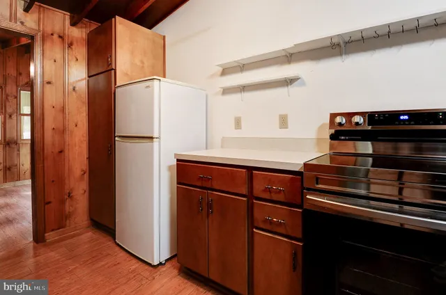 a kitchen with stainless steel appliances granite countertop a refrigerator and a stove