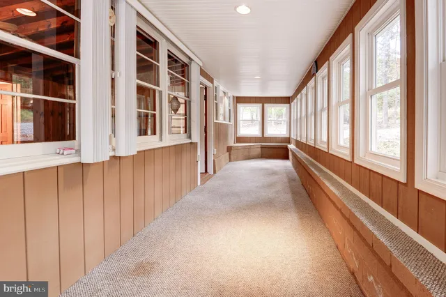 a view of an entryway with wooden floor and windows