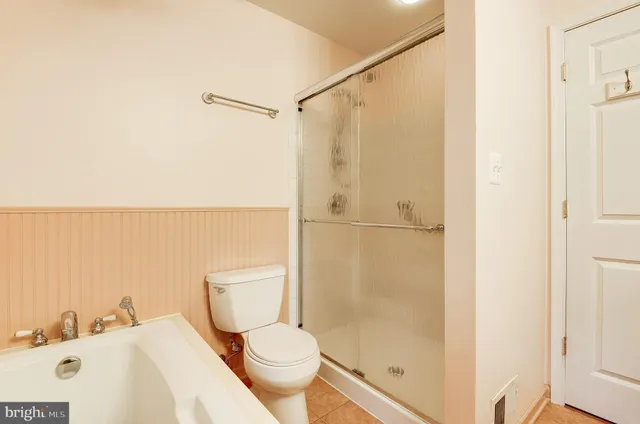 a bathroom with a toilet and a shower