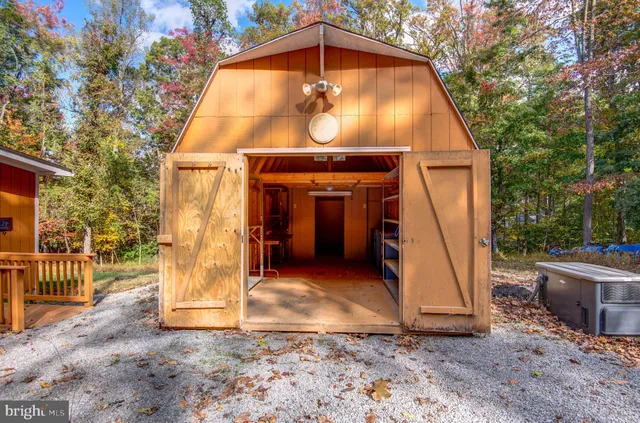 a view of a wooden door with a small yard