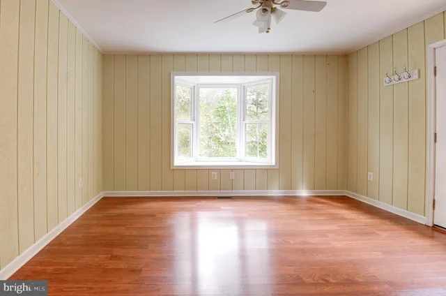 wooden floor in an empty room with a window