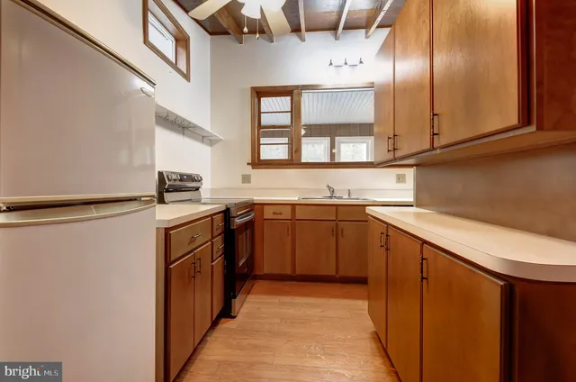 a kitchen with stainless steel appliances granite countertop a sink and cabinets