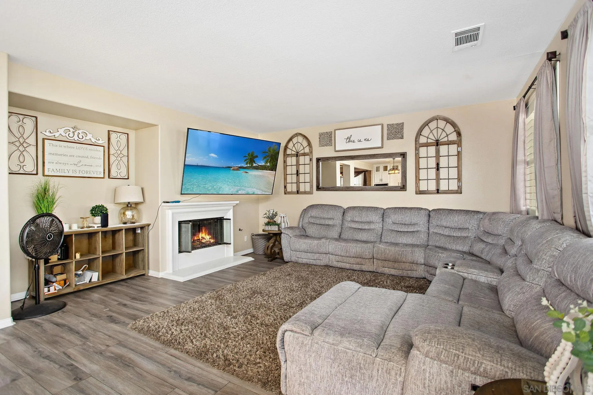 16627 Eagle Peak Road Riverside, CA 92504 - Photo 13 of 38 a living room with furniture a fireplace and a flat screen tv
