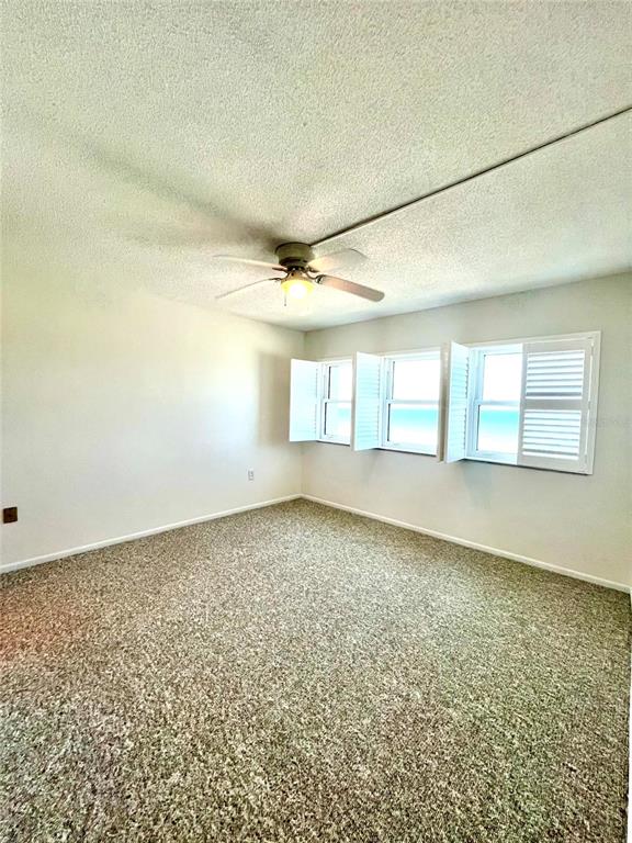 633 Alhambra Road, Unit 703 Venice, FL 34285 - Photo 11 of 15 an empty room with a empty space and windows