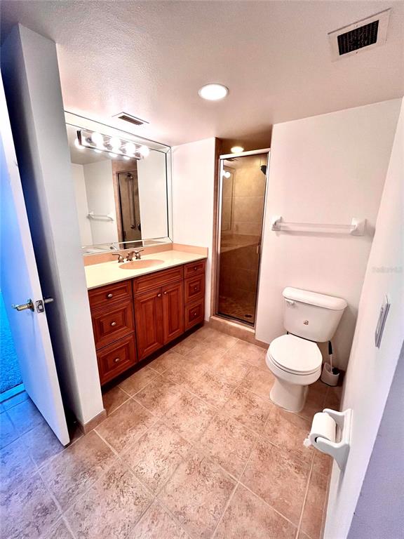 633 Alhambra Road, Unit 703 Venice, FL 34285 - Photo 12 of 15 a bathroom with a granite countertop sink toilet and shower