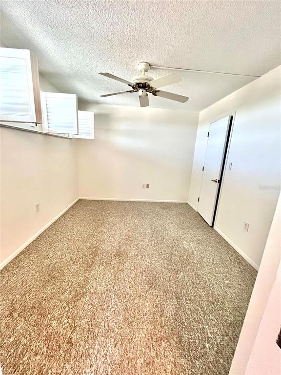 633 Alhambra Road, Unit 703 Venice, FL 34285 - Photo 13 of 15 en empty room with wooden floor and fan