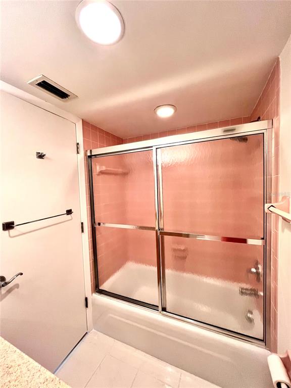 633 Alhambra Road, Unit 703 Venice, FL 34285 - Photo 15 of 15 a bathroom with a glass shower door