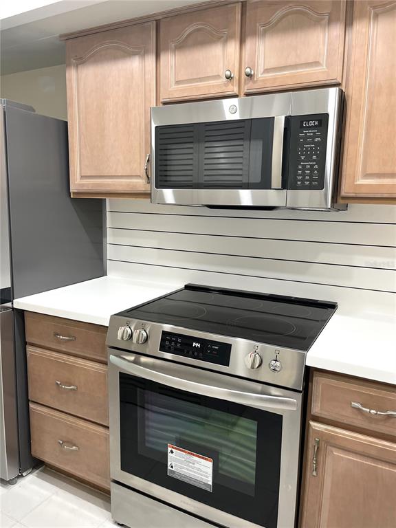 633 Alhambra Road, Unit 703 Venice, FL 34285 - Photo 8 of 15 a stove top oven sitting inside of a kitchen