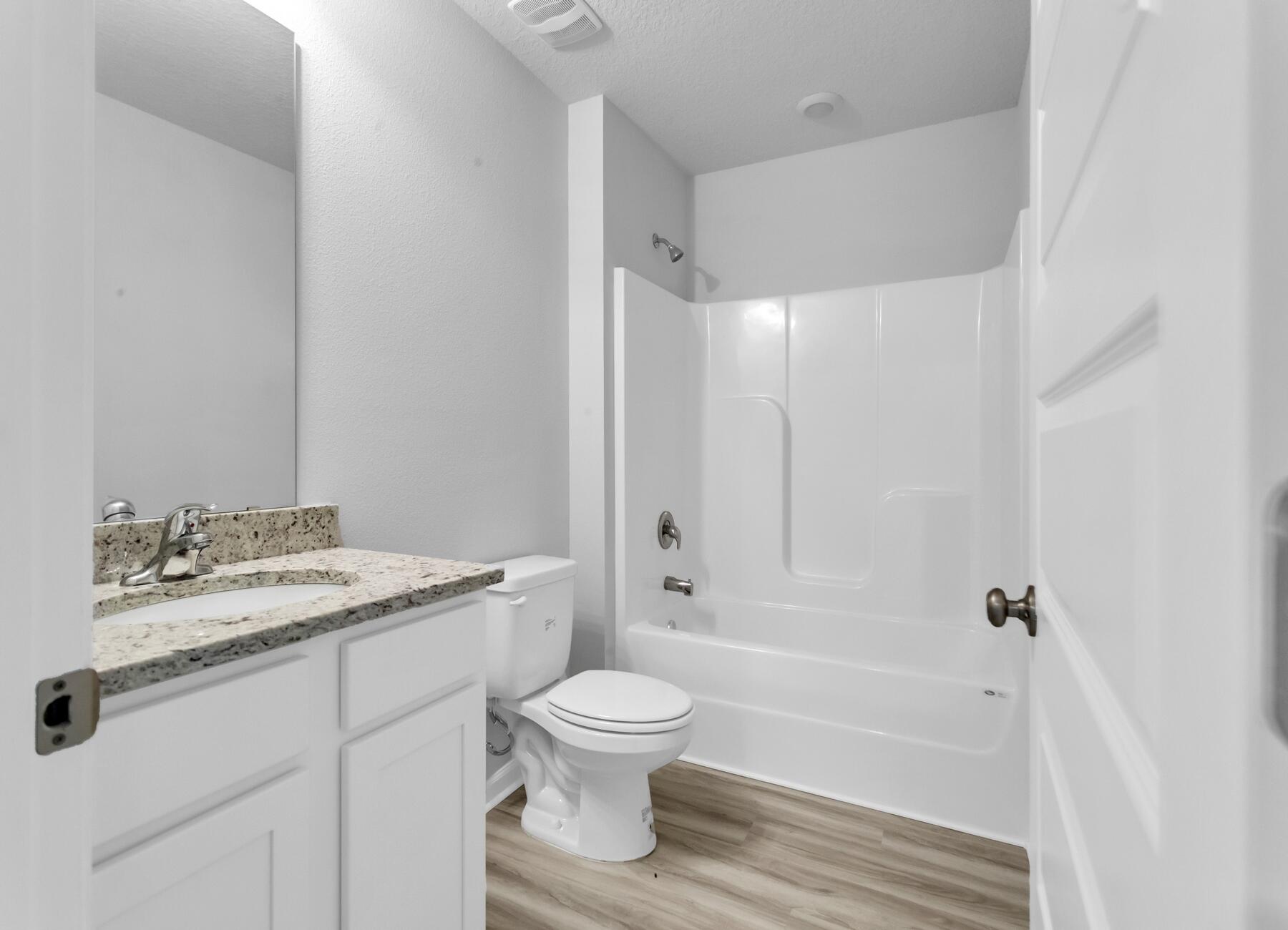 839 Otto Loop Crestview, FL 32539 - Photo 12 of 34 a bathroom with a granite countertop sink toilet a mirror and shower