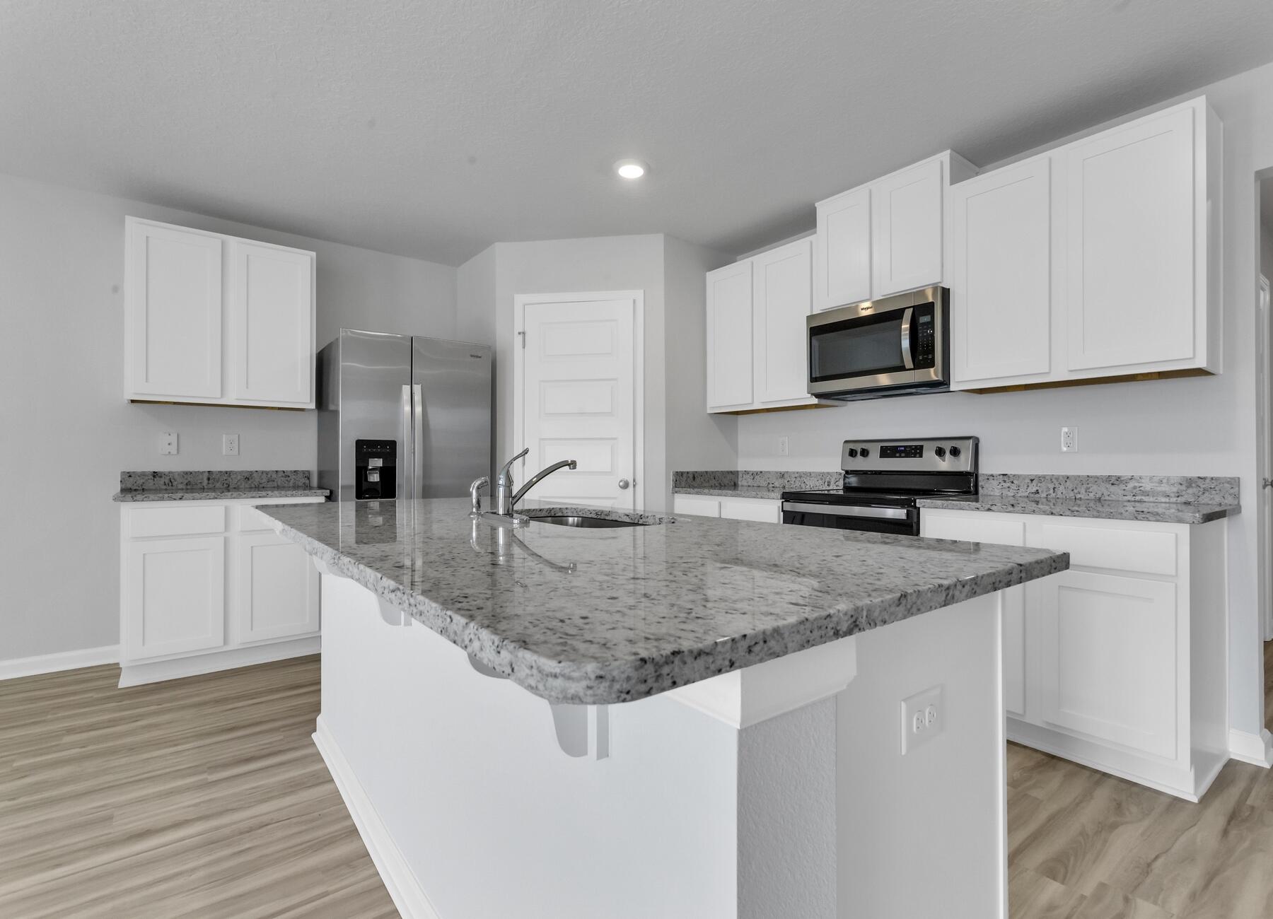 839 Otto Loop Crestview, FL 32539 - Photo 16 of 34 a kitchen with stainless steel appliances granite countertop a sink a stove a microwave and cabinets