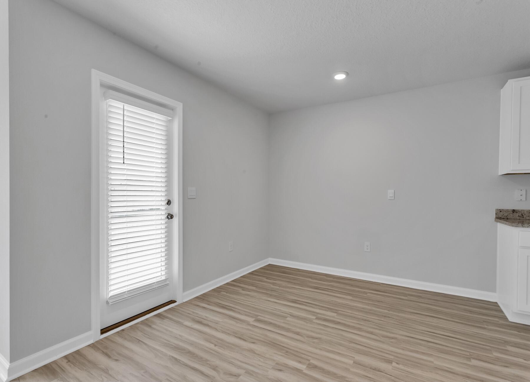 839 Otto Loop Crestview, FL 32539 - Photo 20 of 34 wooden floor in an empty room with a window