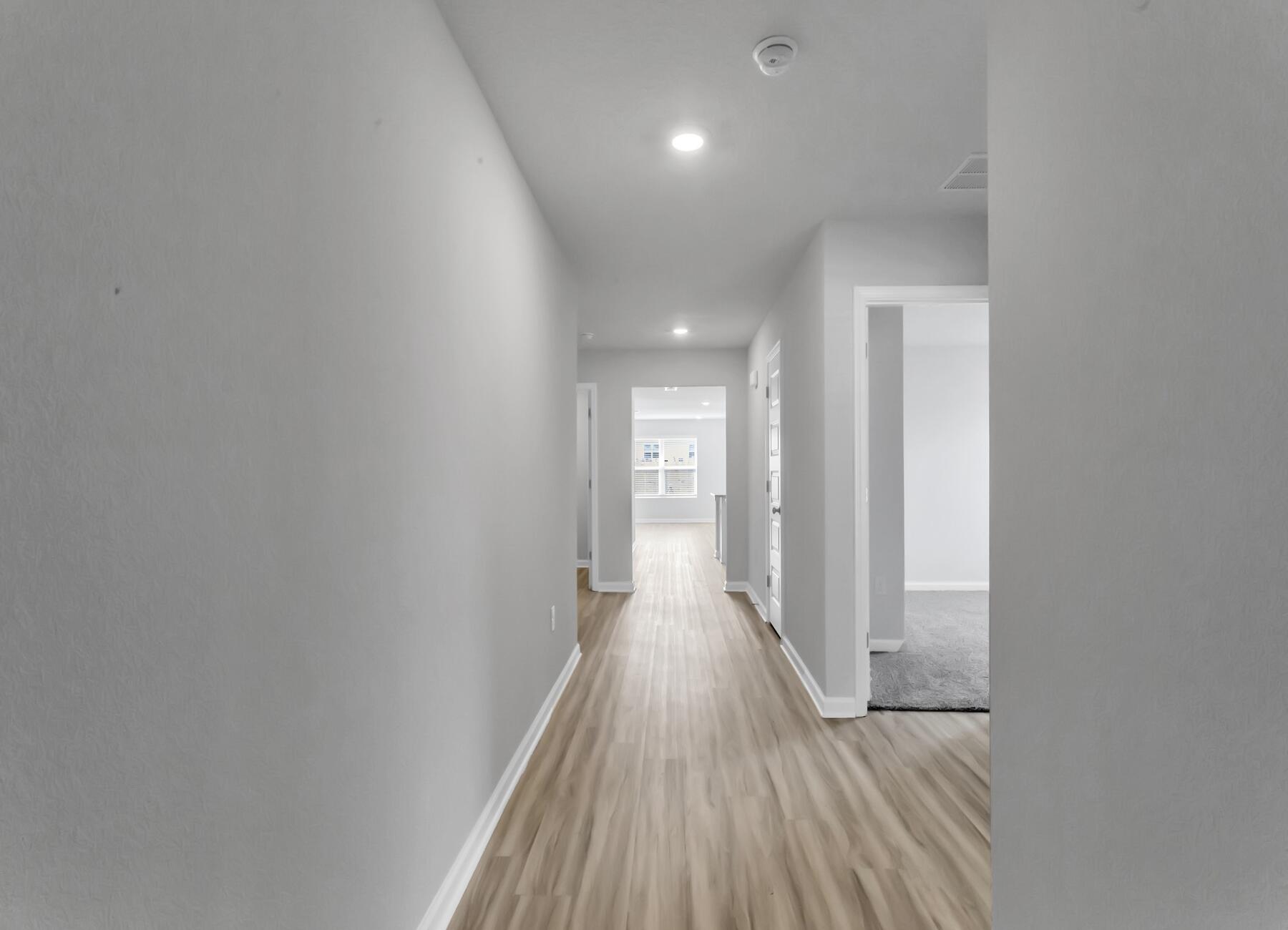 839 Otto Loop Crestview, FL 32539 - Photo 2 of 34 a view of a hallway with wooden floor