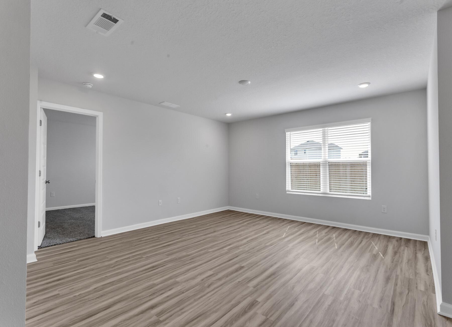 839 Otto Loop Crestview, FL 32539 - Photo 21 of 34 a view of an empty room with wooden floor and a window