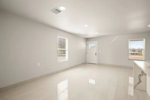 a kitchen with stainless steel appliances a refrigerator sink and white cabinets