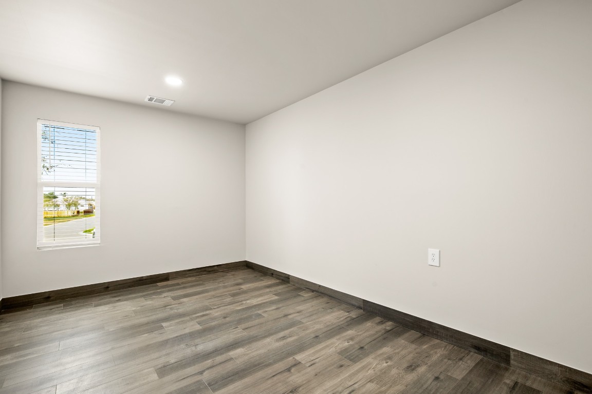 183 Mimosa Road Dale, TX 78616 - Photo 9 of 32 an empty room with wooden floor and windows