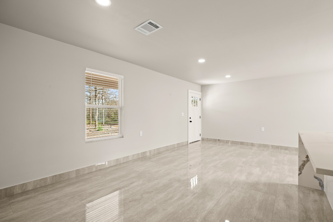 183 Mimosa Road Dale, TX 78616 - Photo 16 of 32 an empty room with wooden floor and windows