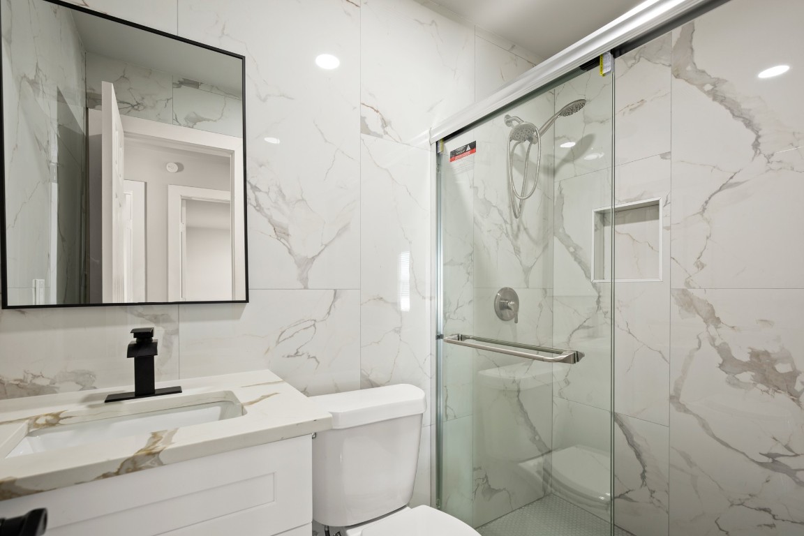 183 Mimosa Road Dale, TX 78616 - Photo 19 of 32 a bathroom with a granite countertop sink toilet and shower