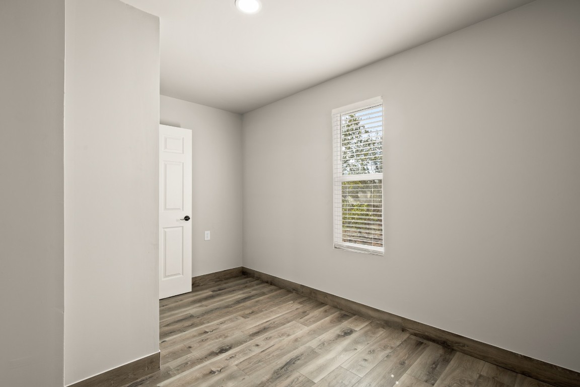 183 Mimosa Road Dale, TX 78616 - Photo 21 of 32 a view of an empty room with wooden floor and a window