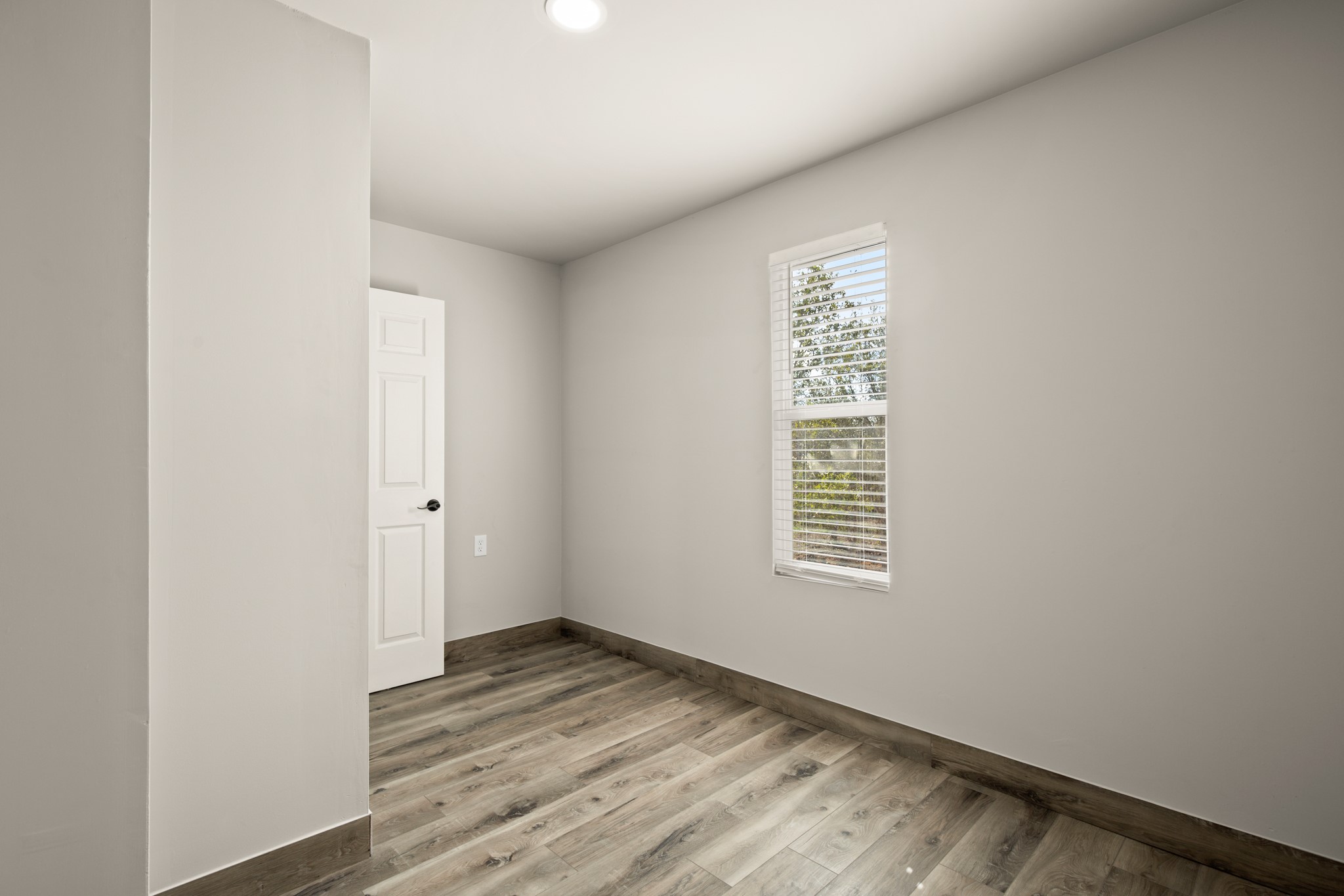 183 Mimosa Road Dale, TX 78616 - Photo 21 of 32 a view of an empty room with wooden floor and a window