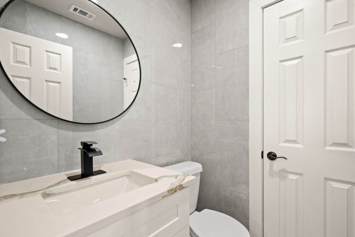 183 Mimosa Road Dale, TX 78616 - Photo 23 of 32 a bathroom with a sink mirror and toilet