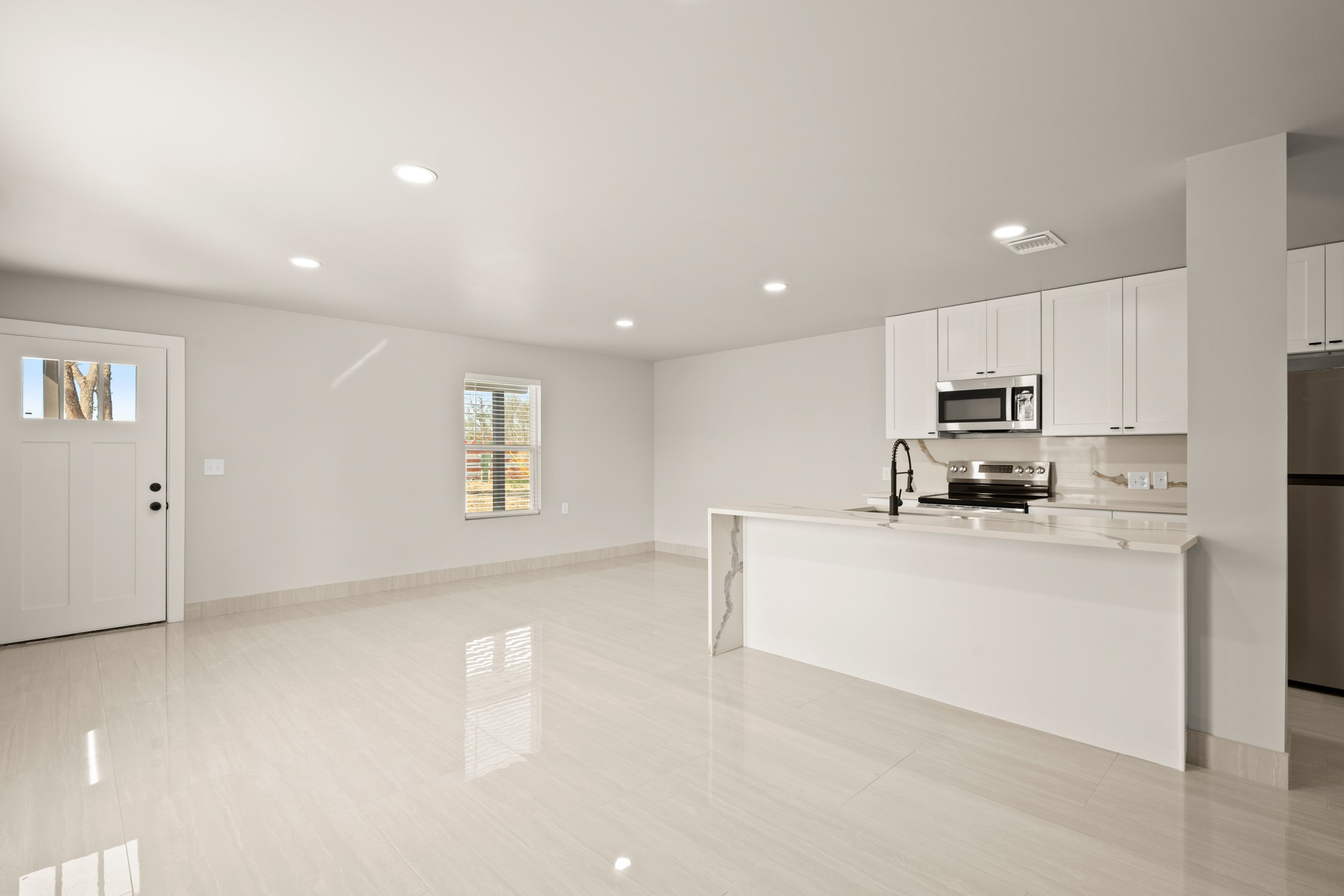 183 Mimosa Road Dale, TX 78616 - Photo 30 of 32 a living room with stainless steel appliances a refrigerator a stove top oven a sink and cabinets