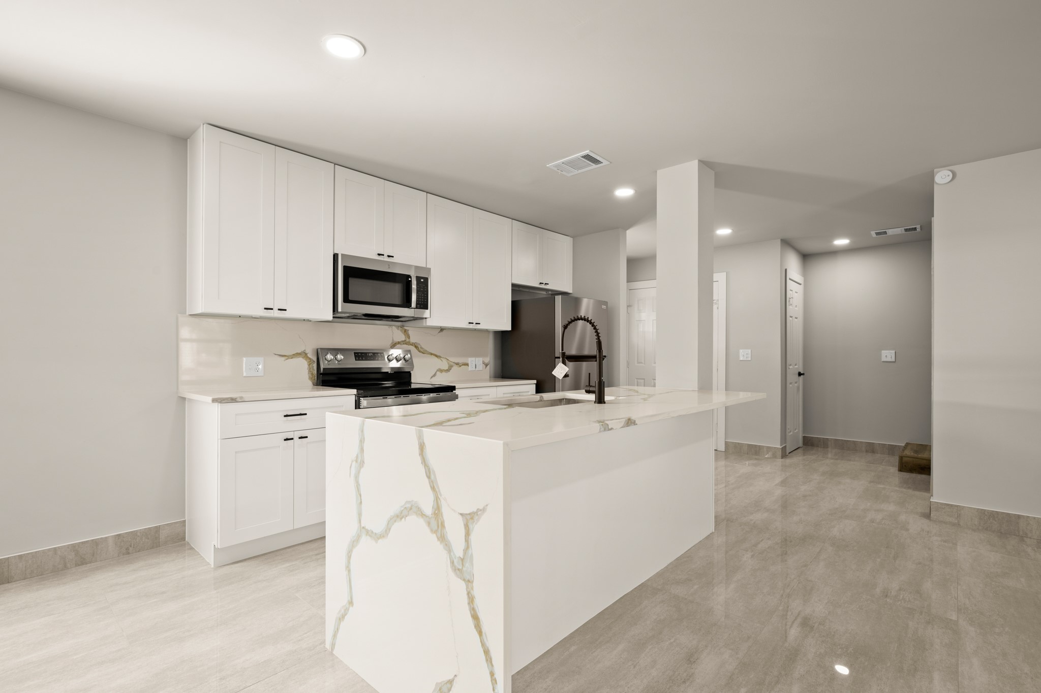 183 Mimosa Road Dale, TX 78616 - Photo 5 of 32 a kitchen with stainless steel appliances a refrigerator sink and white cabinets