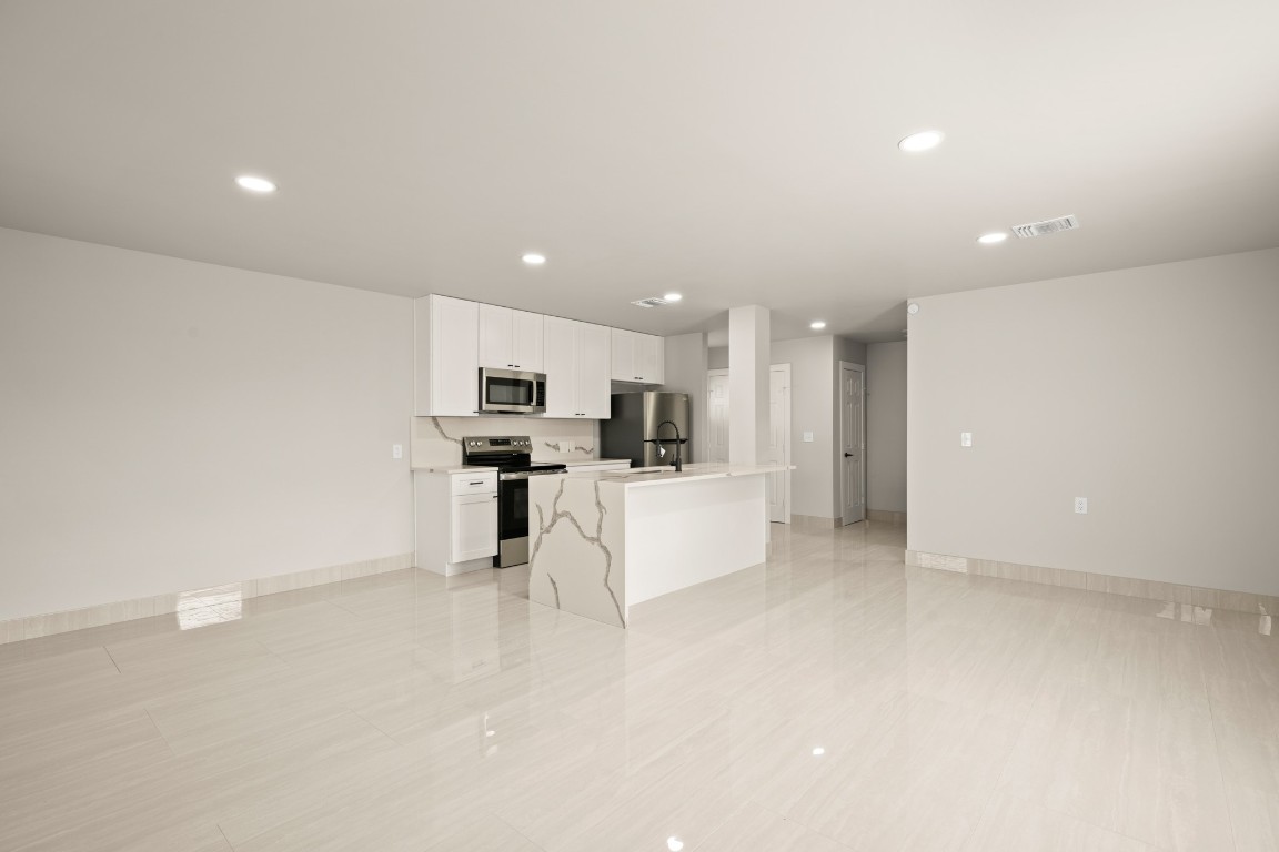 183 Mimosa Road Dale, TX 78616 - Photo 32 of 32 a view of kitchen with kitchen island a sink a stove and a refrigerator