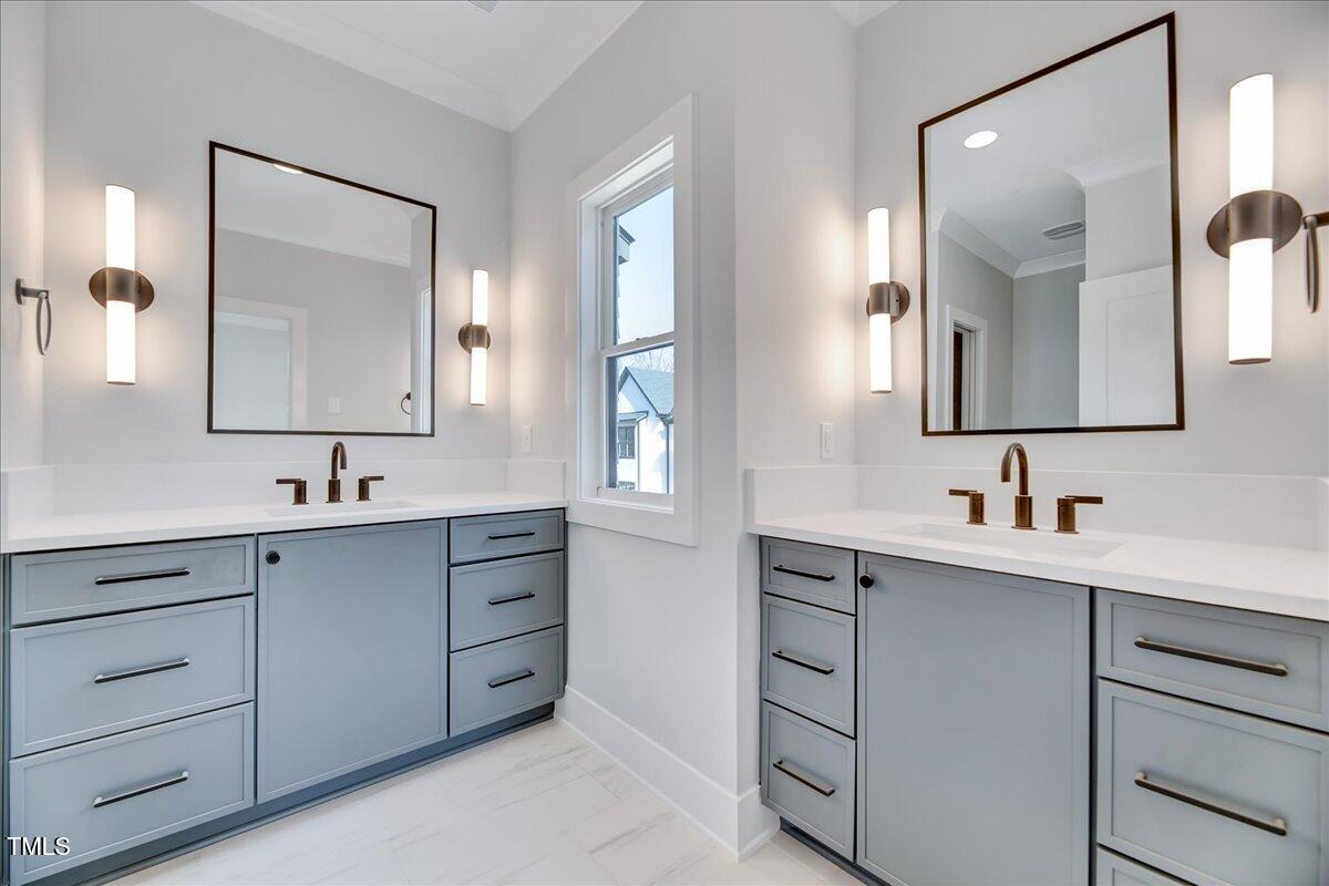 811 Maple Berry Lane, Unit 106 Raleigh, NC 27607 - Photo 13 of 30 a bathroom with a double vanity sink and mirror