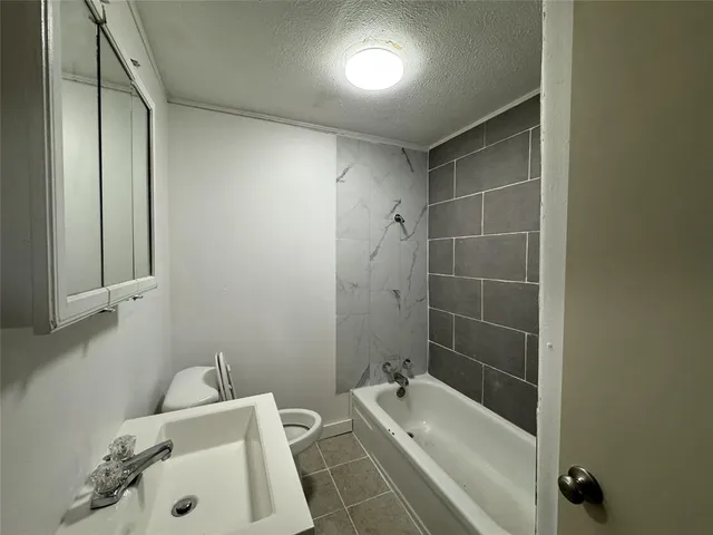 a bathroom with a bathtub and shower