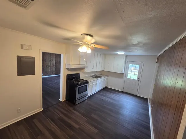 a large living room with a fireplace and wooden floor