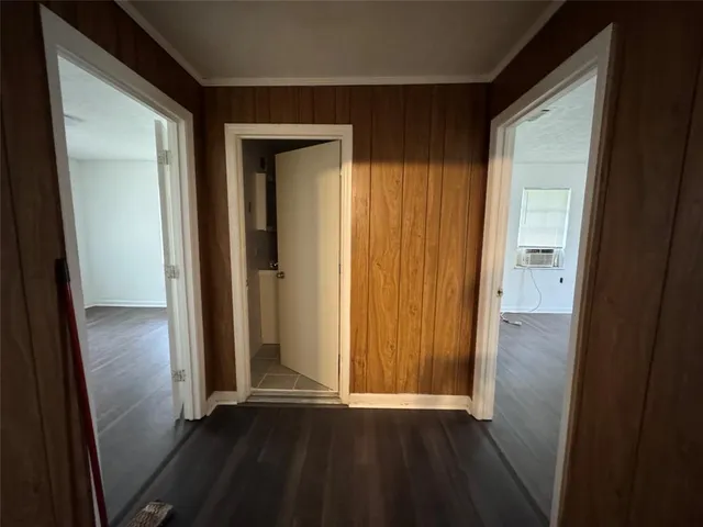 an empty room with wooden floor and a sink