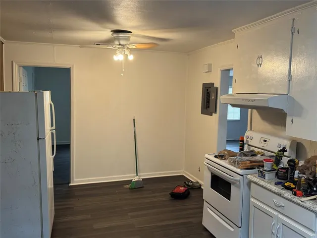 a view of kitchen with refrigerator stove and wooden floor