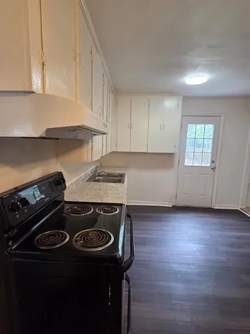 a stove top oven sitting inside of a kitchen