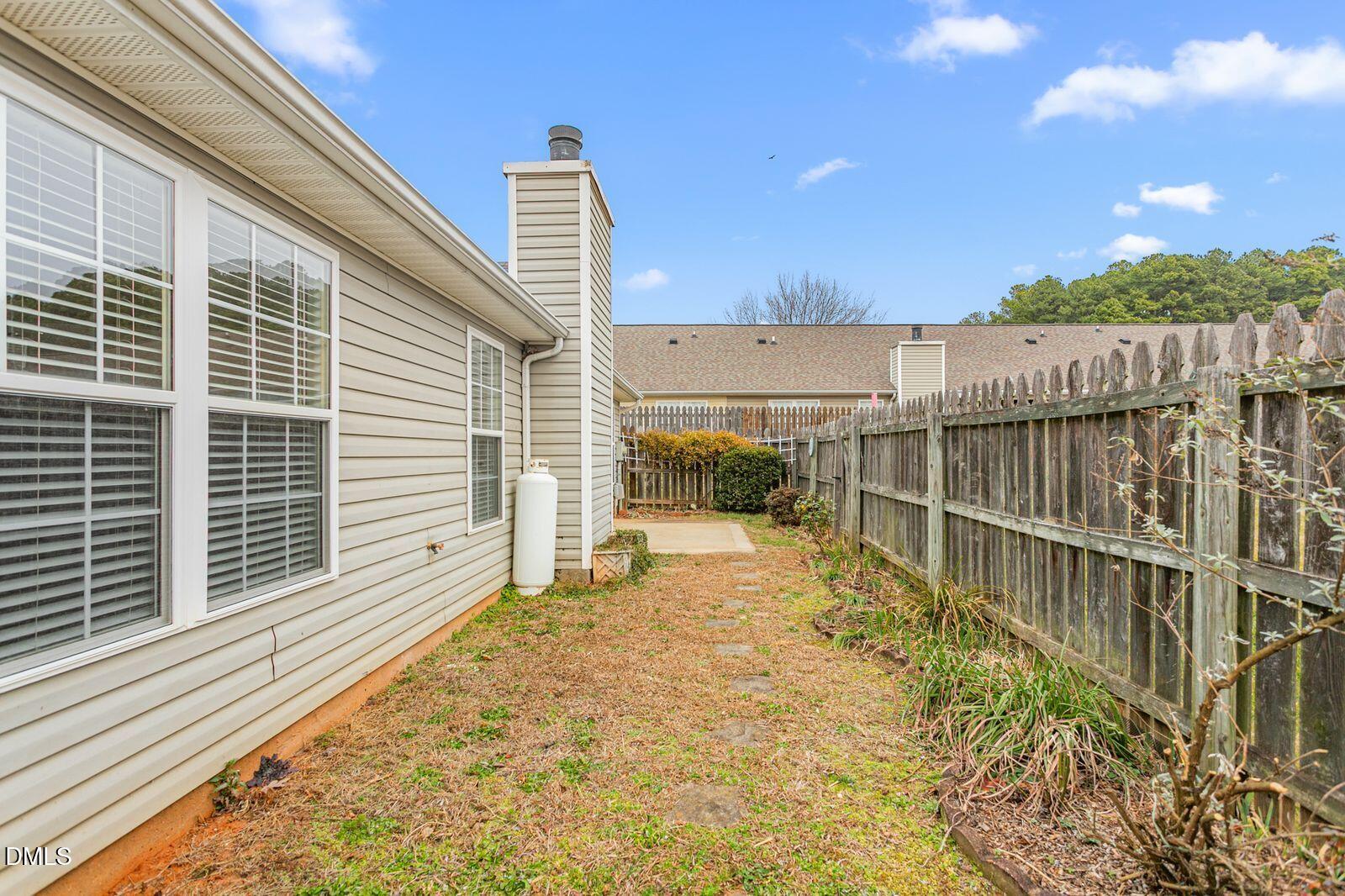 605 Huntingdon Street Elon, NC 27244 - Photo 16 of 18 a view of a balcony with floor to ceiling window next to a yard