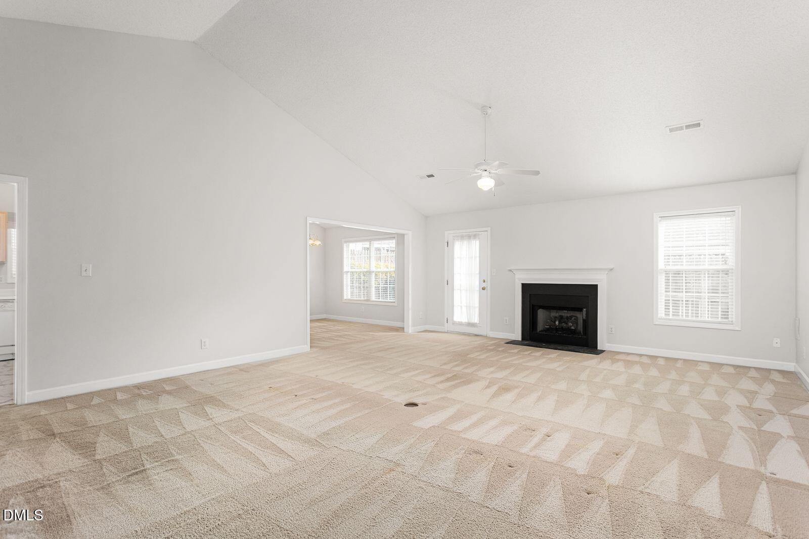 605 Huntingdon Street Elon, NC 27244 - Photo 3 of 18 a view of an empty room with a fireplace and a window