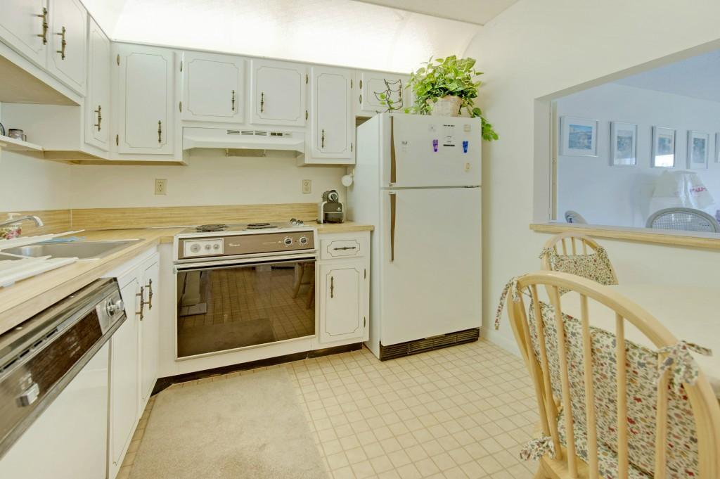 9440 Southwest 8th Street, Unit 220 Boca Raton, FL 33428 - Photo 1 of 9 a kitchen with a stove a refrigerator and a sink