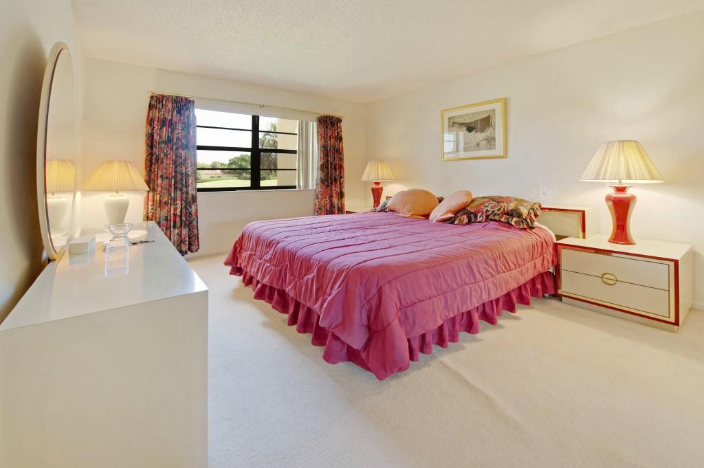 9440 Southwest 8th Street, Unit 220 Boca Raton, FL 33428 - Photo 3 of 9 a bedroom with bed and window