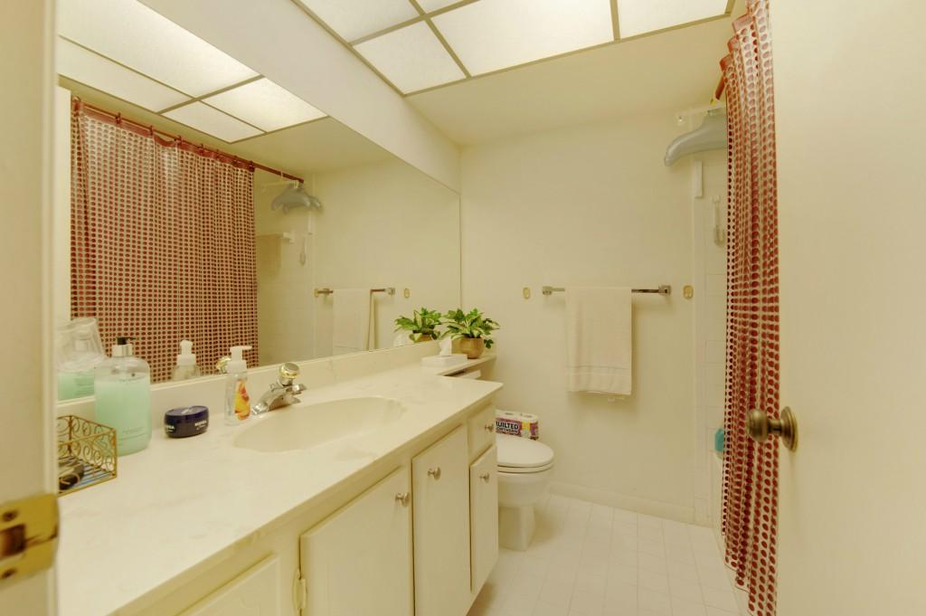 9440 Southwest 8th Street, Unit 220 Boca Raton, FL 33428 - Photo 4 of 9 a bathroom with a sink mirror and a toilet