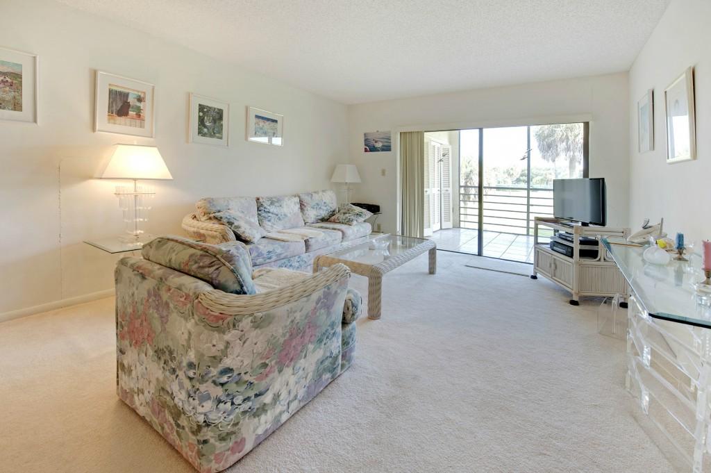 9440 Southwest 8th Street, Unit 220 Boca Raton, FL 33428 - Photo 5 of 9 a living room with furniture and a flat screen tv