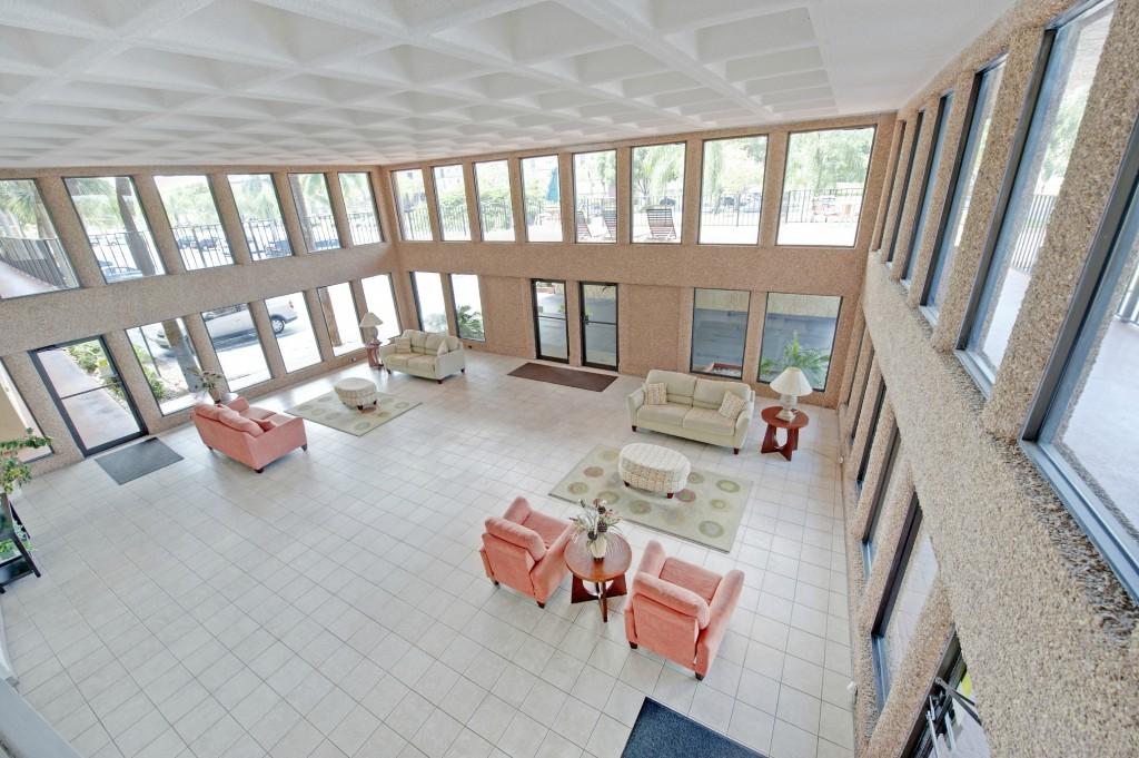 9440 Southwest 8th Street, Unit 220 Boca Raton, FL 33428 - Photo 8 of 9 a living room with furniture and a large window