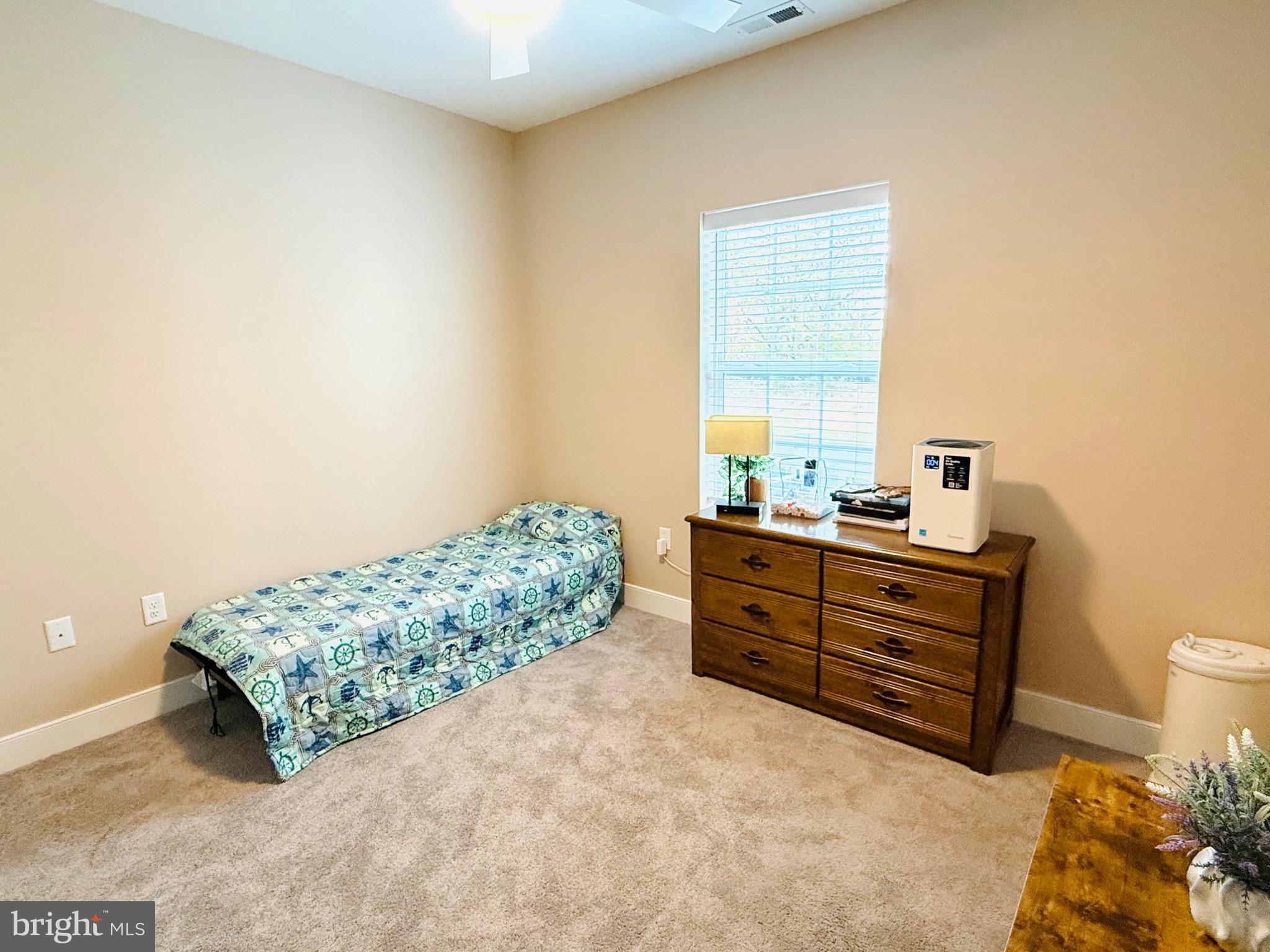 30609 Cedar Neck Road, Unit 3103 Ocean View, DE 19970 - Photo 11 of 39 a room with a bed and a dresser