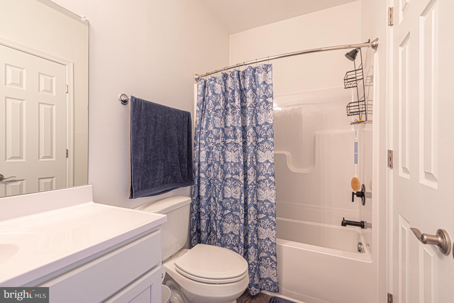 30609 Cedar Neck Road, Unit 3103 Ocean View, DE 19970 - Photo 19 of 39 a bathroom with a bathtub shower sink vanity and toilet